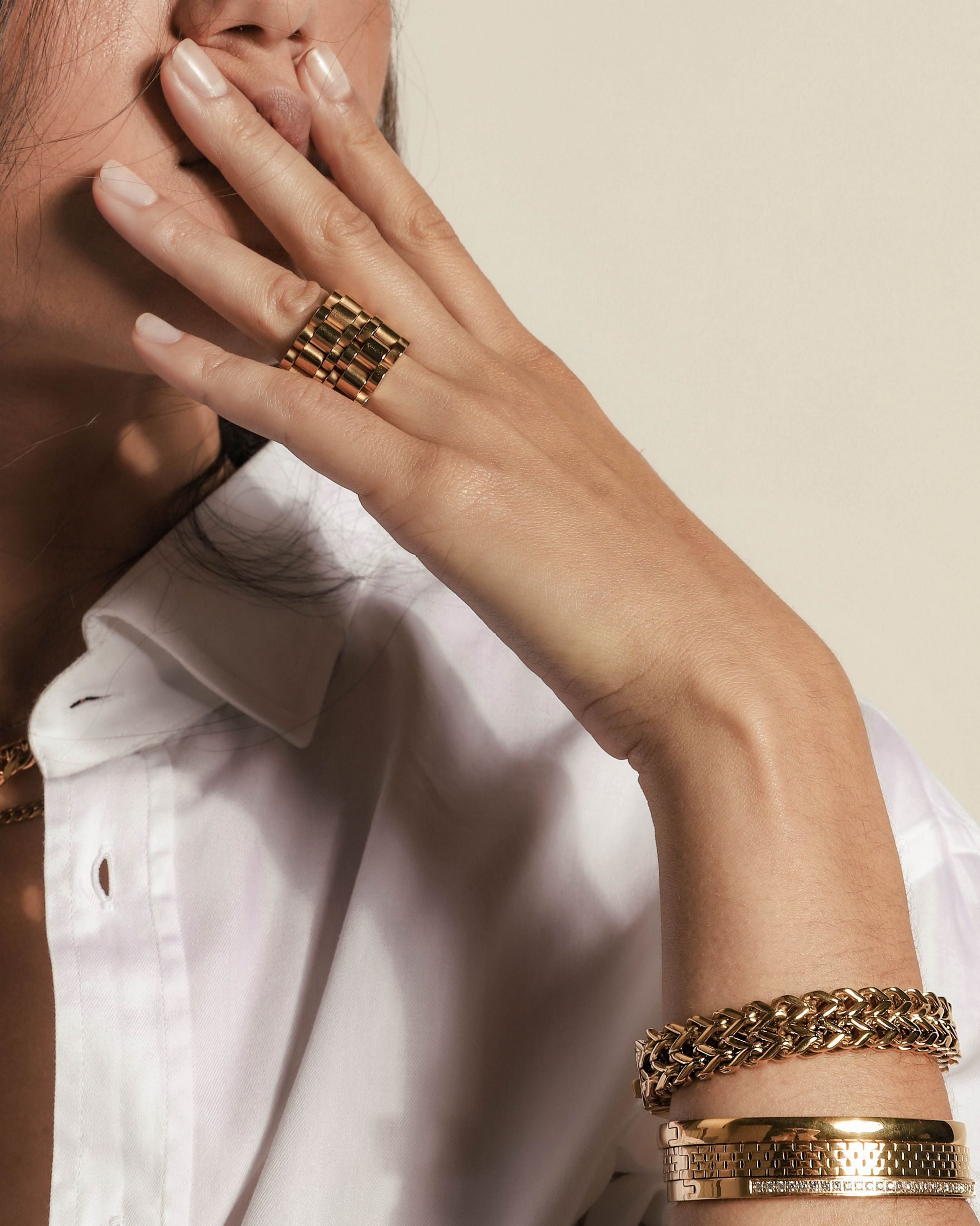 Model wearing layered necklaces, two gold chain rings, marinero bracelet, the DUO stack and the Dust bangle. ||| GOLD