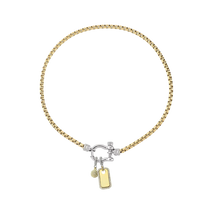 The Herradura Signature Charm Party, a mixed-metal necklace featuring a gold chain, silver-tone herradura clasp, and 2 charm accents. ||| SILVER