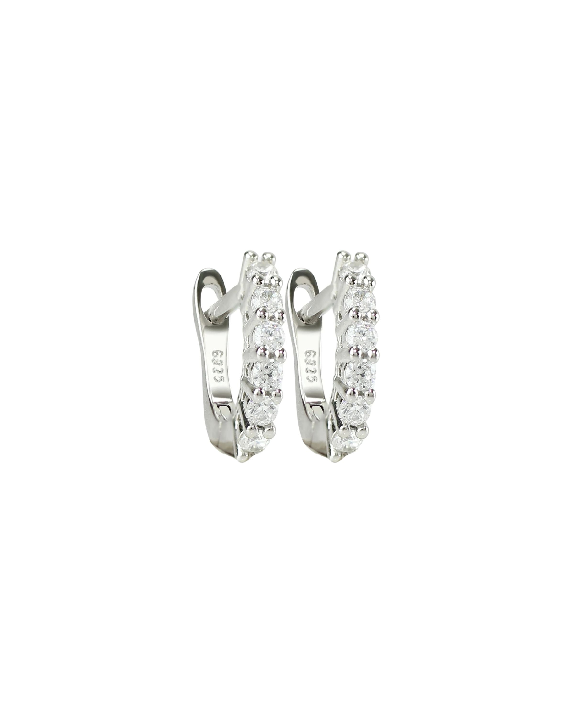 The Prong Hoops, which are a pair of silver hoop earrings, feature a stunning row of sparkling prong-set cubic zirconia stones along the front for a dazzling effect. These elegant hoops are perfect for adding a touch of glamour to any outfit, making them versatile for both everyday wear and special occasions ||| SILVER