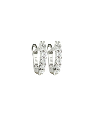 The Prong Hoops, which are a pair of silver hoop earrings, feature a stunning row of sparkling prong-set cubic zirconia stones along the front for a dazzling effect. These elegant hoops are perfect for adding a touch of glamour to any outfit, making them versatile for both everyday wear and special occasions ||| SILVER