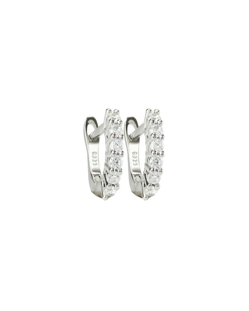 The Prong Hoops, which are a pair of silver hoop earrings, feature a stunning row of sparkling prong-set cubic zirconia stones along the front for a dazzling effect. These elegant hoops are perfect for adding a touch of glamour to any outfit, making them versatile for both everyday wear and special occasions ||| SILVER