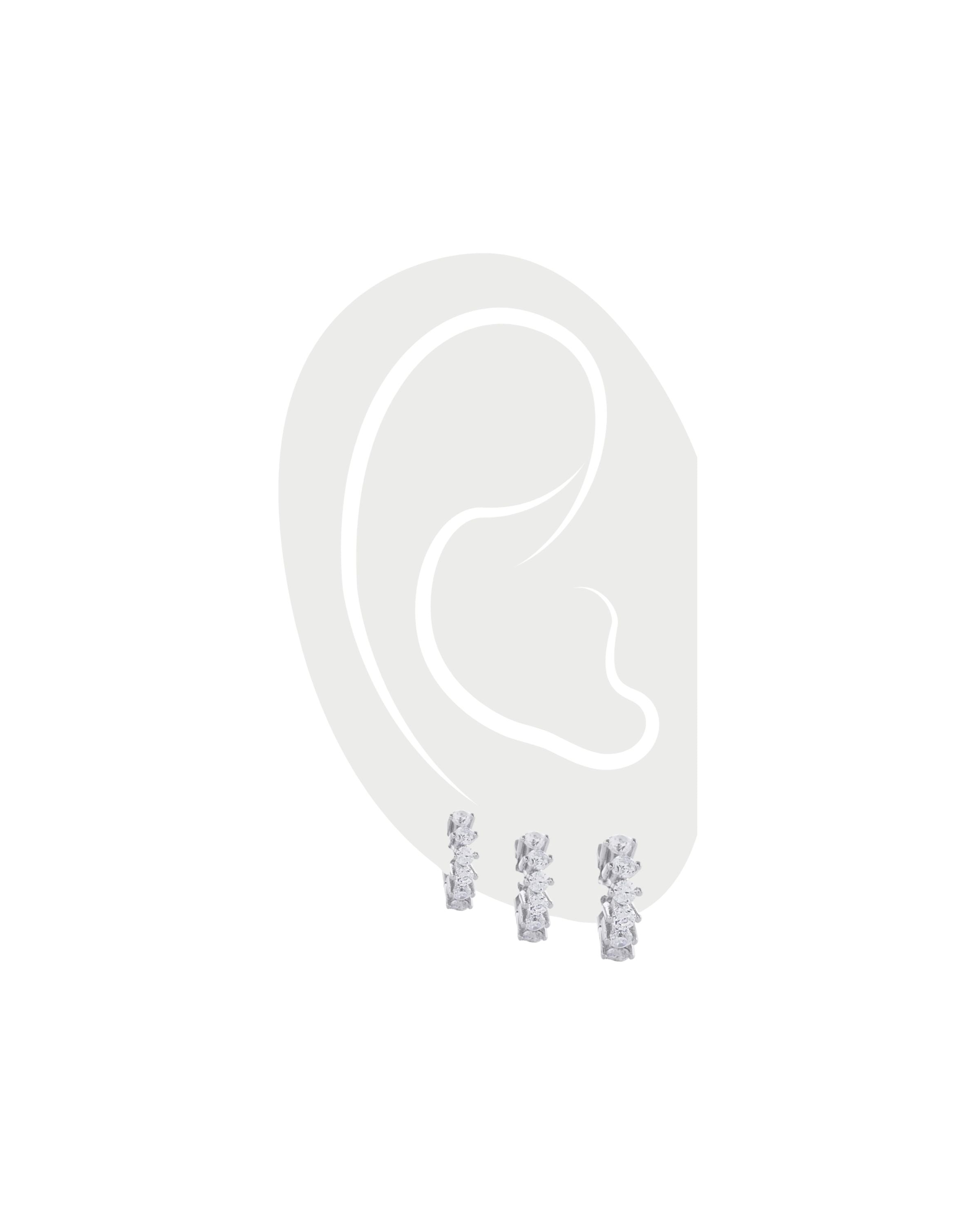 The Tiny Huggies Hoop Set, a trio of silver-tone hoops with intricate details, perfect for stacking or wearing individually. ||| SILVER