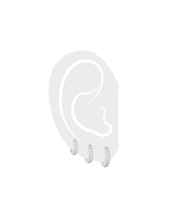 The Mini Clear Huggies Set, a set of three silver-tone huggie earrings with clear stones, perfect for stacking or solo wear.||| SILVER