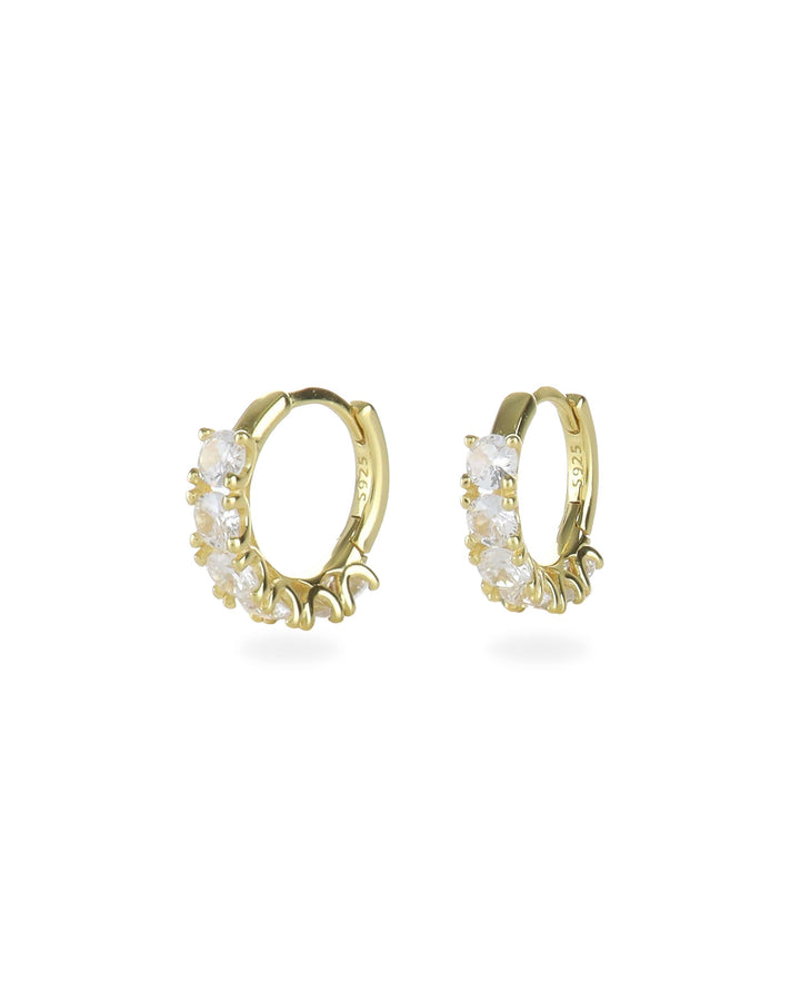 The Gold Crown Hoops Piercings, a pair of elegant gold hoop earrings adorned with a row of prong-set crystals.