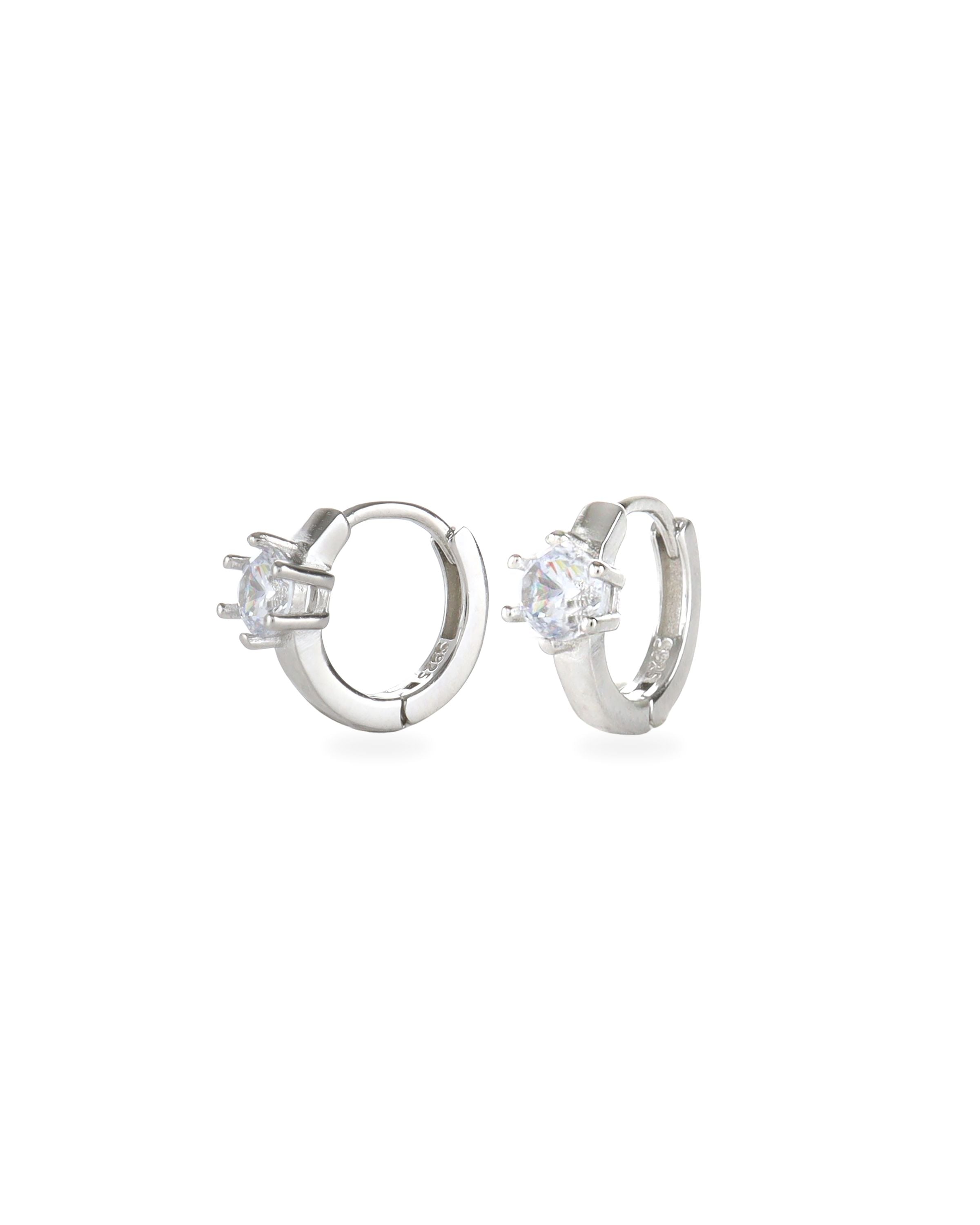 The Forever Piercing Hoops, a pair of sleek silver hoop earrings each adorned with a single prong-set crystal. 