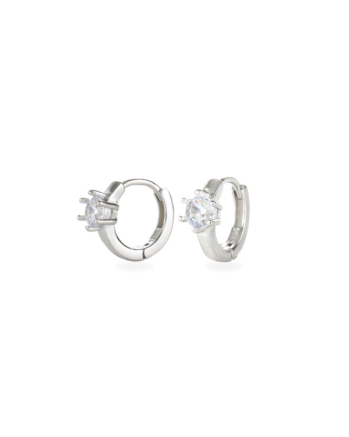 The Forever Piercing Hoops, a pair of sleek silver hoop earrings each adorned with a single prong-set crystal. 