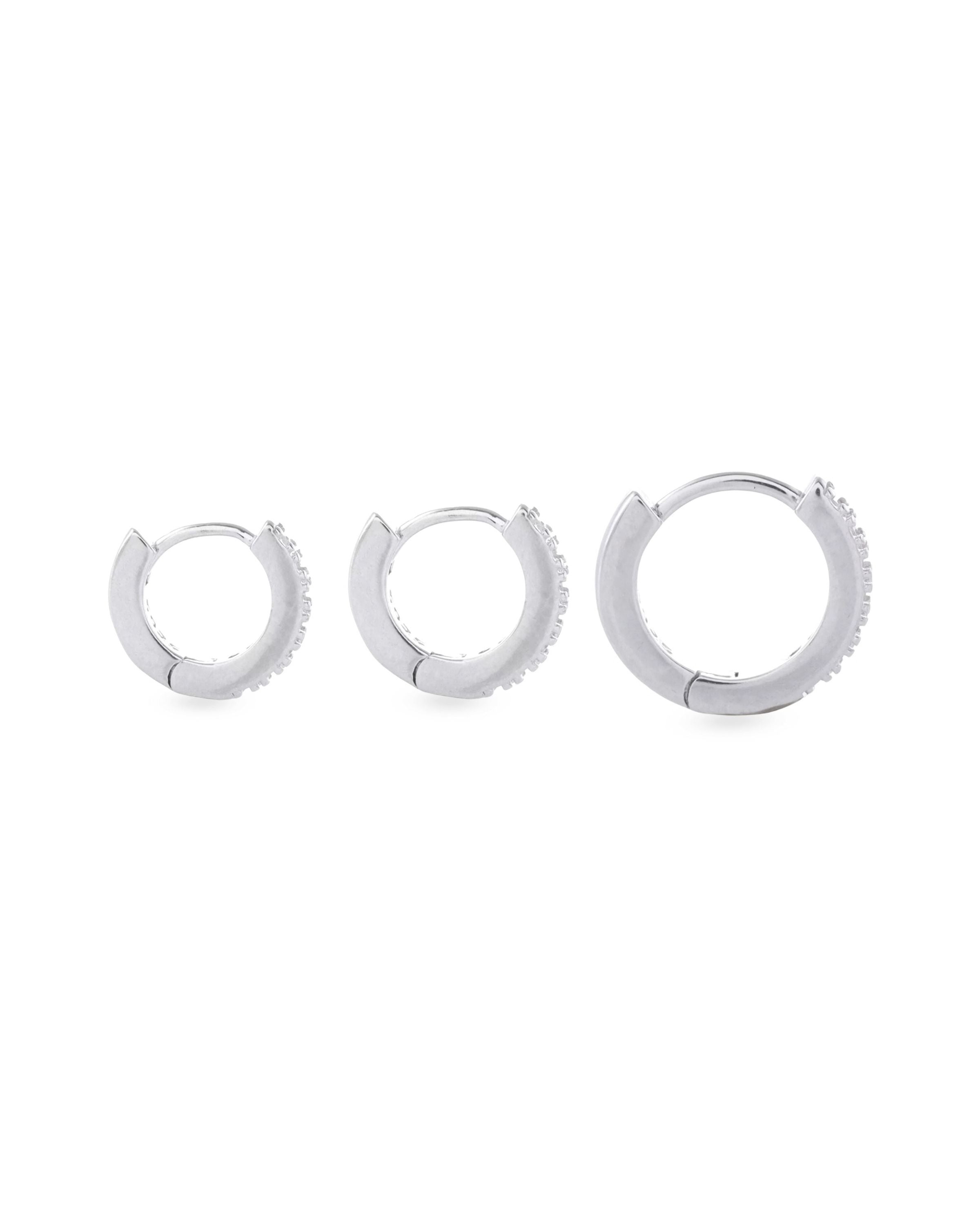 The Mini Clear Huggies, a pair of small silver hoop earrings with sparkling clear cubic zirconia stones.||| SILVER