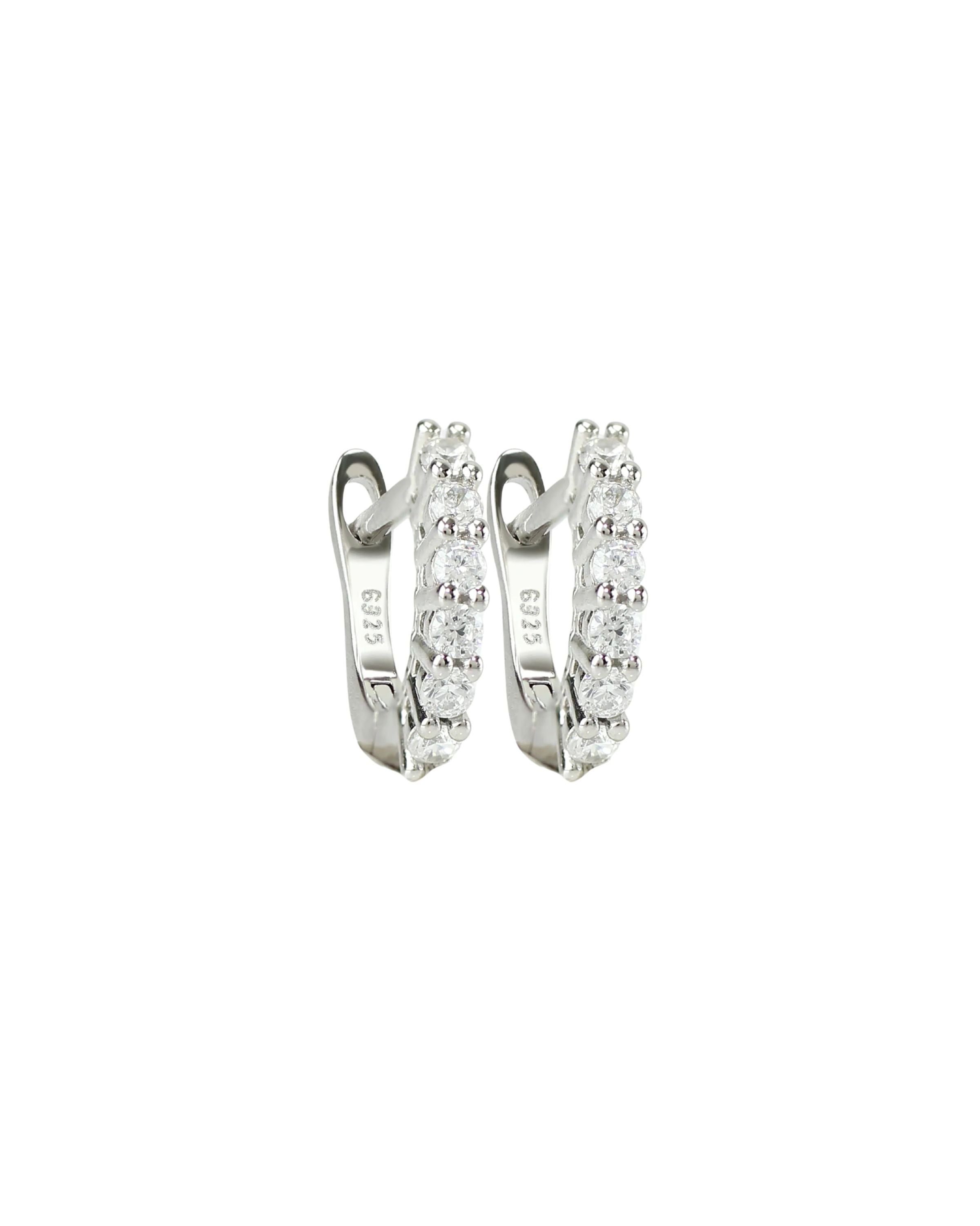 The Prong Hoops, which are a pair of silver hoop earrings, feature a stunning row of sparkling prong-set cubic zirconia stones along the front for a dazzling effect. These elegant hoops are perfect for adding a touch of glamour to any outfit, making them versatile for both everyday wear and special occasions ||| SILVER