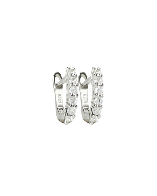 The Prong Hoops, which are a pair of silver hoop earrings, feature a stunning row of sparkling prong-set cubic zirconia stones along the front for a dazzling effect. These elegant hoops are perfect for adding a touch of glamour to any outfit, making them versatile for both everyday wear and special occasions ||| SILVER