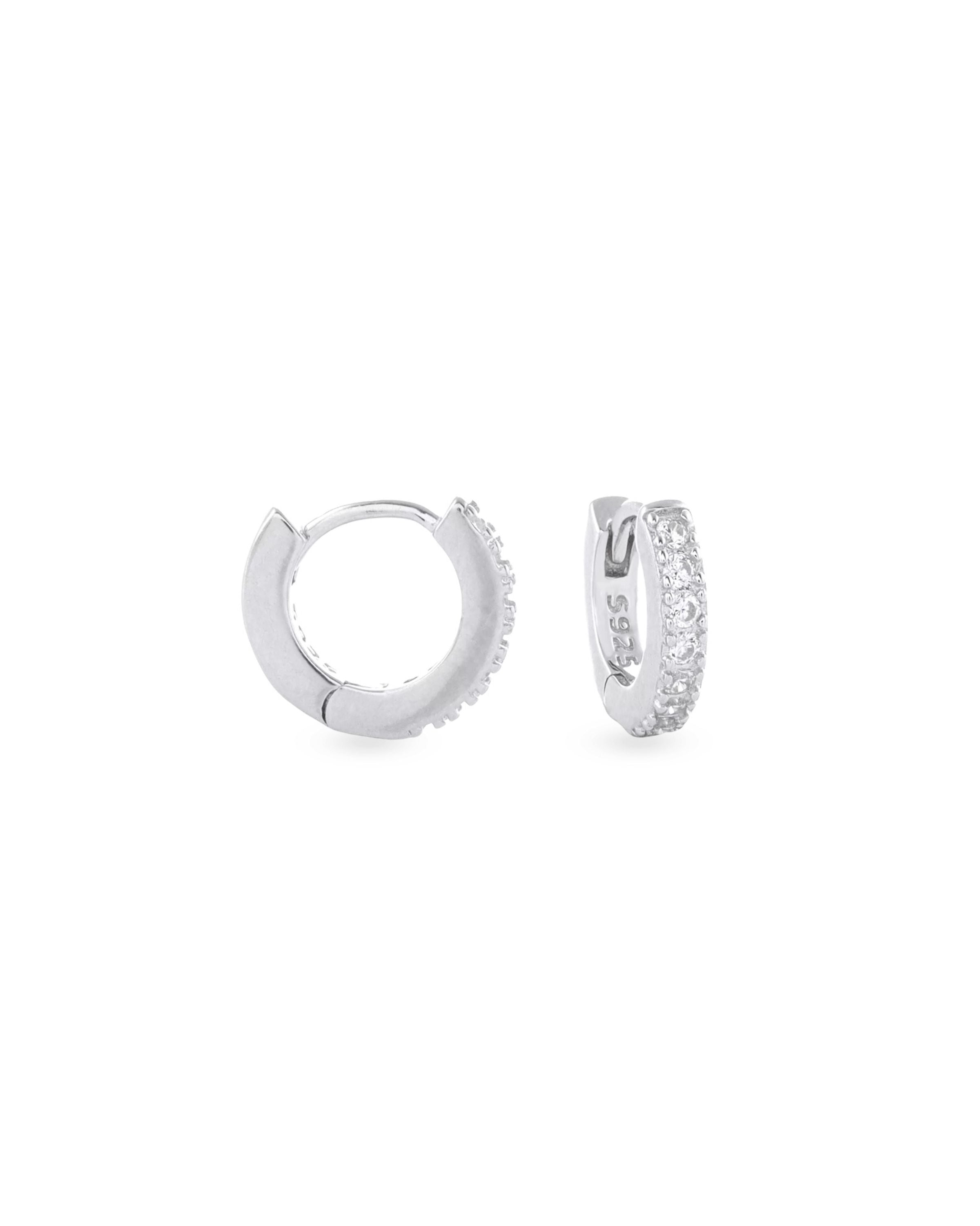 The Mini Clear Huggies, a pair of small silver hoop earrings with sparkling clear cubic zirconia stones. ||| SILVER