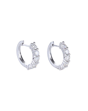 The Main Hoop, which is a pair of silver-tone hoop earrings featuring a row of dazzling round-cut stones along the front, offering a statement design that combines elegance and brilliance for any occasion.