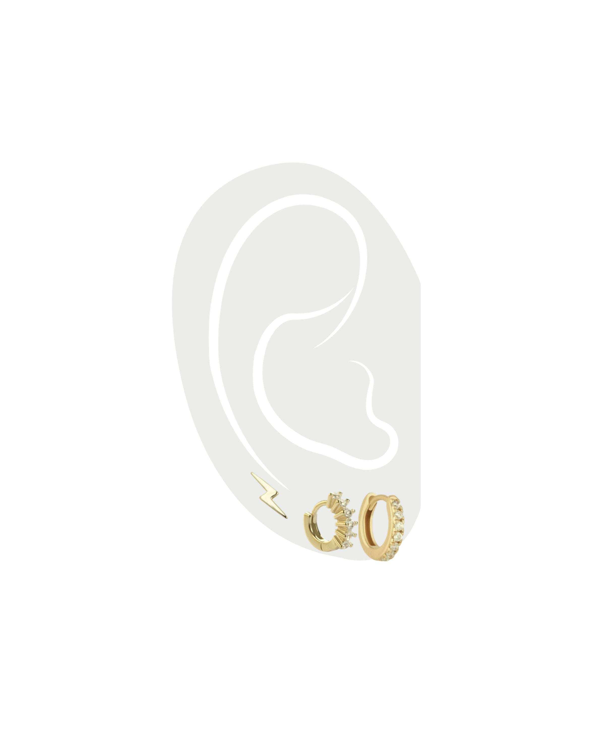The ELBA EAR SET - 3 & 2 HOLES which comes with five earrings. a pair of tiny huggies earrings, pair of MINI CLEAR GOLD HUGGIES that are 18k gold plated with cubic zirconia and one tiny lightning earring in gold as well.