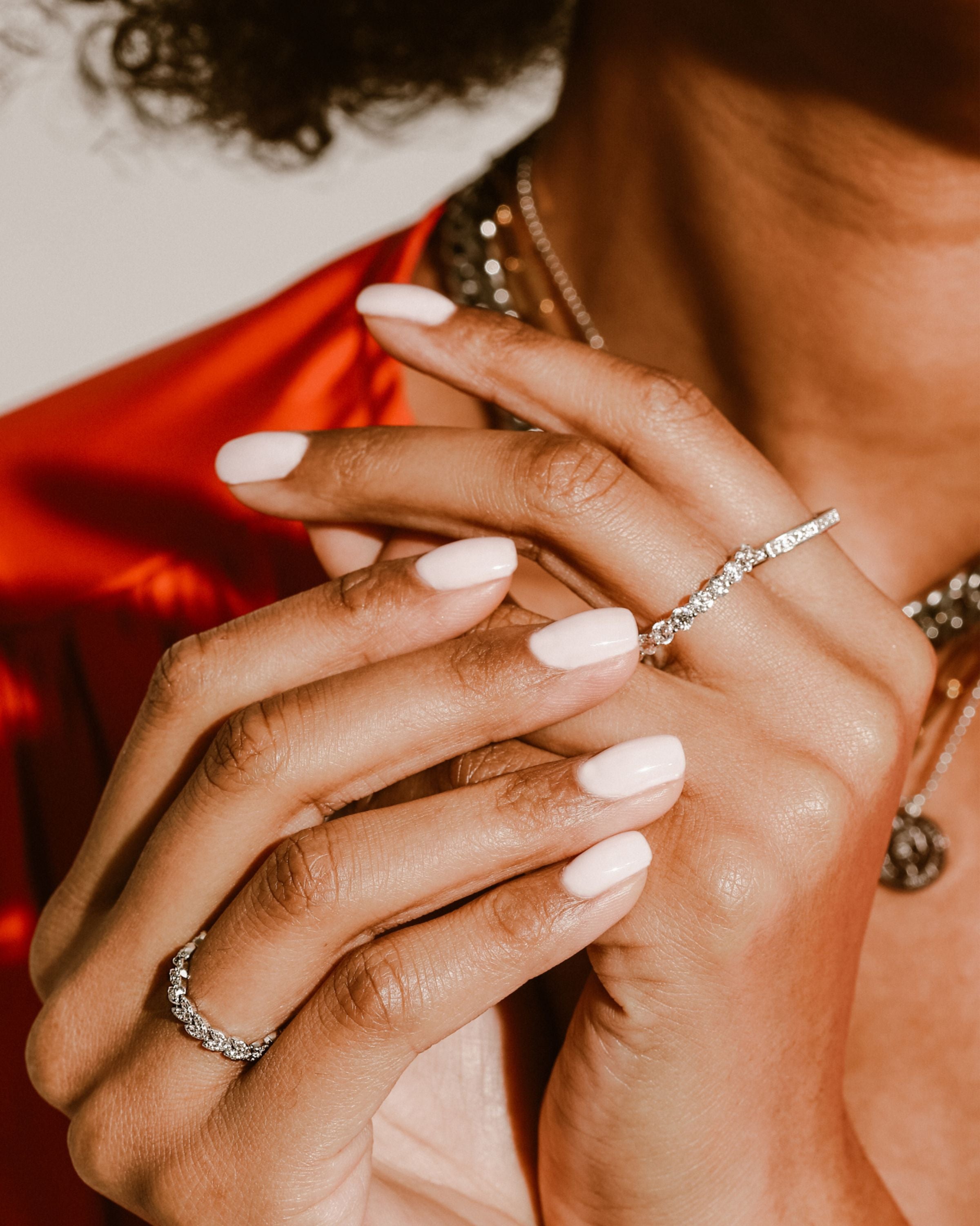 Model wearing the Eternity ring which is 3mm in width made of 925 sterling silver covered with Cubic zirconia. and also two other silver with zirconia rings.