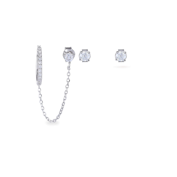 The Ear Cuff with Chain Set, which is a four-pieceThe Ear Cuff with Chain Set, which is a four-piece silver earring set, features a sparkling ear cuff connected by a delicate chain to a stud, accompanied by two additional solitaire studs for versatile styling options and an elegant, contemporary look.