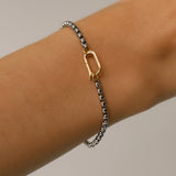 Model wearing the Unique Can Opener Box Chain Bracelet featuring a distinctive silver link design and a secure gold can opener clasp ||| SILVER