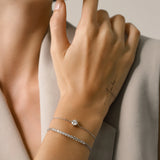 Model wearing a Sparkling Diamond Tennis Bracelet with Adjustable Slider Closure and another thin bracelet with one diamond.