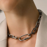 Model wearing the Carabiner Square Puerto Necklace, which is a silver chain necklace featuring a unique silver carabiner clasp. ||| SILVER