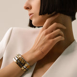 The Triangle Stack, which is a set of five elegant bangles, features a blend of gold and silver tones with modern geometric accents. This versatile bracelet stack includes minimalist designs with subtle embellishments, perfect for layering or wearing individually for a chic look.