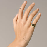 Model wearing the Y Punto Pinky Ring, a gold pinky ring with a minimalist design and a single cubic zirconia stone.
