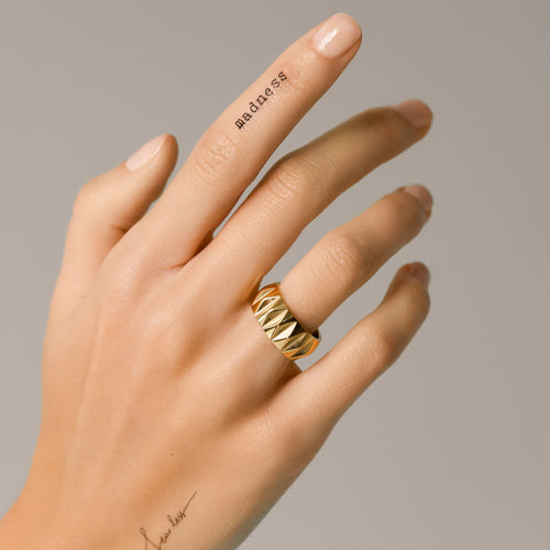 Model''s hand wearing a Gold-plated Stainless Steel Accordion Ring with Geometric Pattern