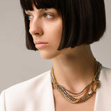 Model wearing the Carabiner Necklace Set, a three-piece gold and silver necklace set featuring Cuban link chains and a carabiner clasp.