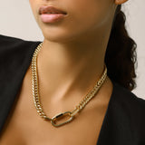 Model wearing the Anne Necklace - A classic gold-tone Cuban chain necklace with a sleek carabiner clasp. ||| Gold