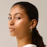 The DRAGON-FLY SINGLE CLIMBER EARRING, which is a single silver ear climber, features a sleek curved design with dazzling stones that elegantly hug the ear. Perfect for adding a modern, minimalist sparkle to your ear stack or wearing as a standout solo piece.