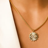 Model wearing the I See Necklace, a luxurious gold chain with a  unique eye-shaped pendant adorned with sparkling diamonds.