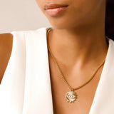 Model wearing the I See Necklace, a luxurious gold chain with a  unique eye-shaped pendant adorned with sparkling diamonds.