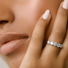 Model wearing the Diamond Band Ring, a silver ring featuring five dazzling brilliant-cut diamonds.