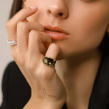 Model wearing the THE ETERNITY RING SET  the Y Punto Pinky Ring, a gold pinky ring with a minimalist design and a single cubic zirconia stone.