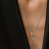 Model wearing the SOLITAIRE LILY NECKLACE which is a thin mini can opener necklace with a mini diamond flower pendant.