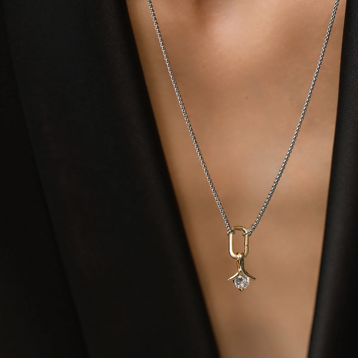 Model wearing the SOLITAIRE LILY NECKLACE which is a thin mini can opener necklace with a mini diamond flower pendant.