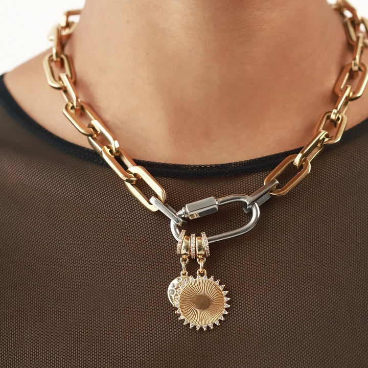 The CARABINER SUN PUERTO NECKLACE with the Dalmatian bulky charm and  the SUNSHINE BULKY CHARM which is made of 18K gold plated sterling silver with encrusted zirconia sunburst charm.