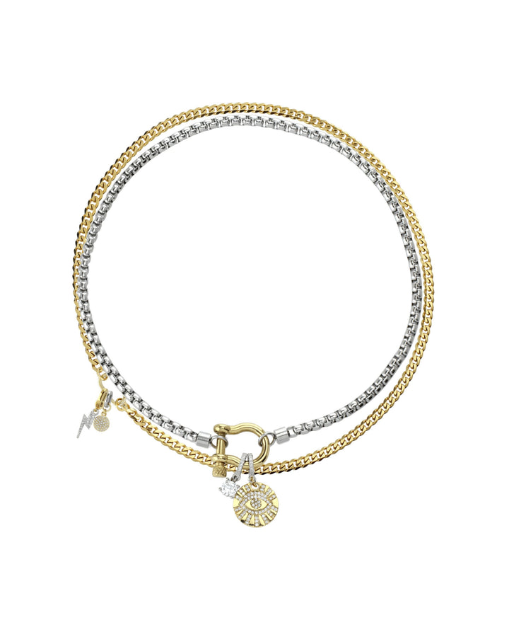 The Herradura Clip On Evil Eye Necklace Set, a two-piece silver and gold necklace set featuring a box chain and a Cuban chain with a gold horseshoe clasp, an evil eye charm, and a lightning bolt charm, all accented with diamond-like stones.