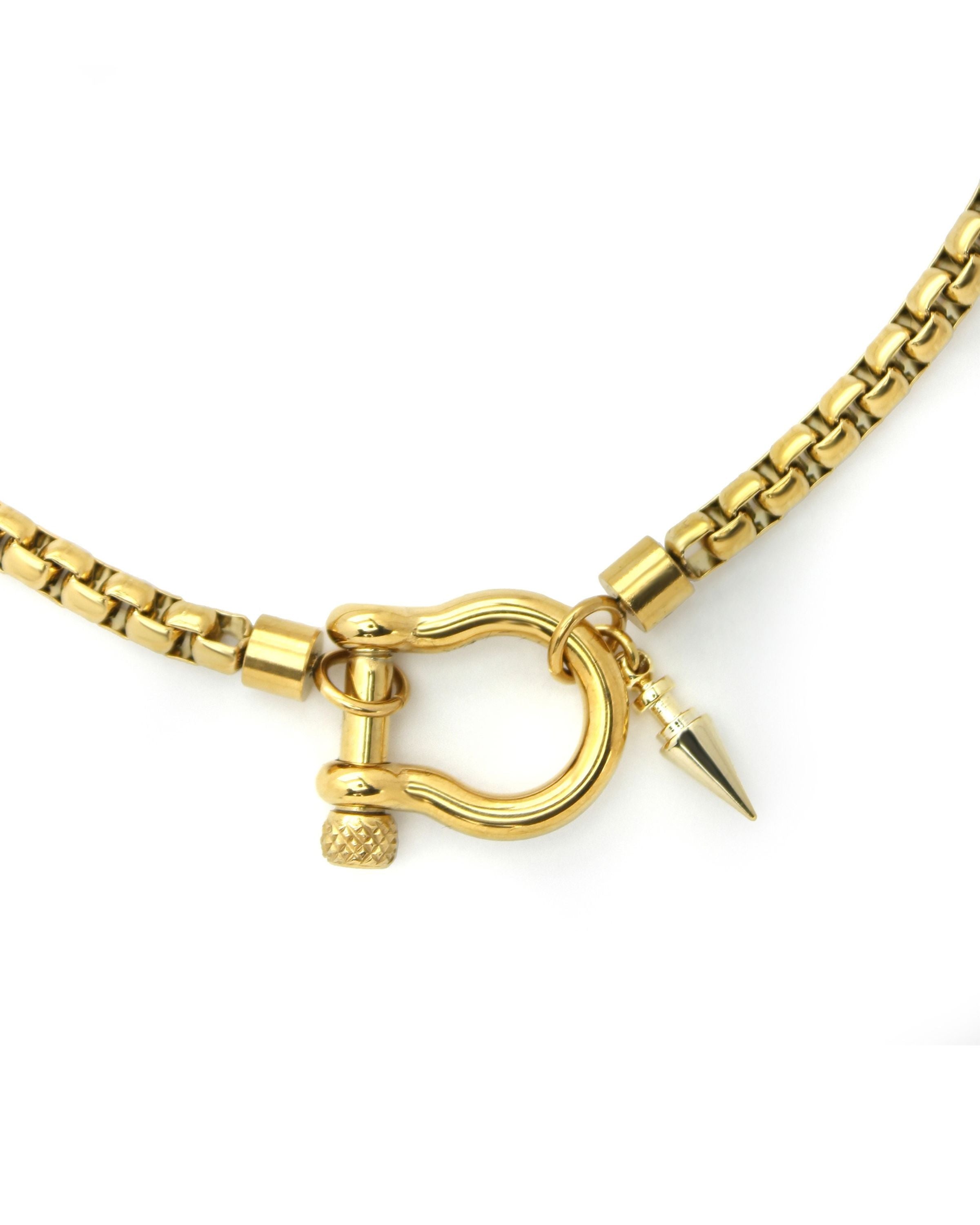 Herradura Spike Necklace which is made of 18k gold plated non tarnish stainless steel chain with gold horseshoe clasp and spike pendant.