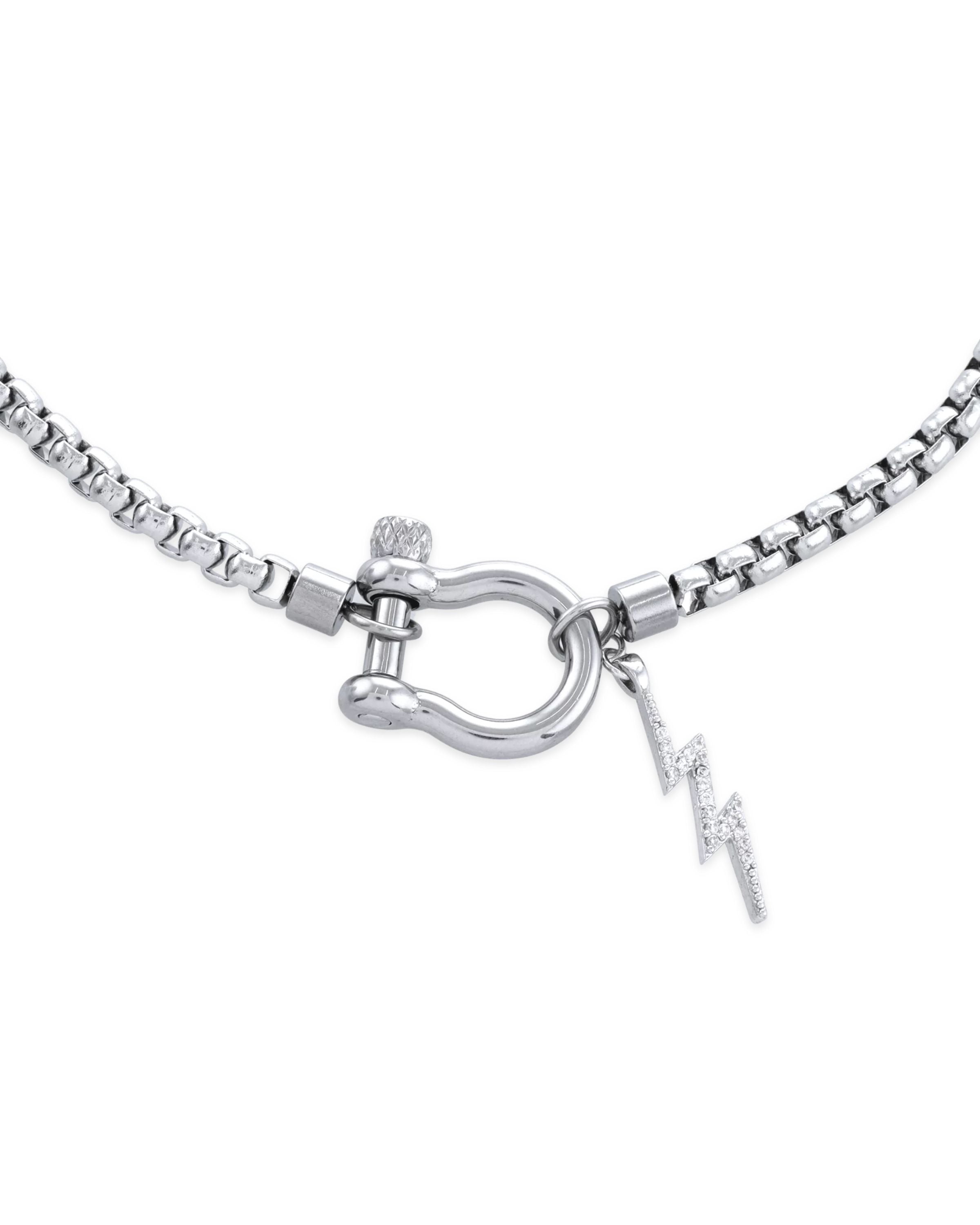 The Herradura Thunder Necklace - Silver, a single silver chain necklace featuring a bold clasp with a lightning bolt charm. This edgy and modern piece adds a touch of sparkle and attitude, perfect for making a statement or layering with other silver accessories.