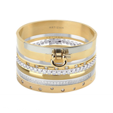 The ICONIC BRACELET STACK which is a stack of 7 gold and silver bracelets, including designs with crystal accents and a gold bracelet featuring a bold buckle clasp.