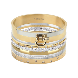 The ICONIC BRACELET STACK which is a stack of 7 gold and silver bracelets, including designs with crystal accents and a gold bracelet featuring a bold buckle clasp.