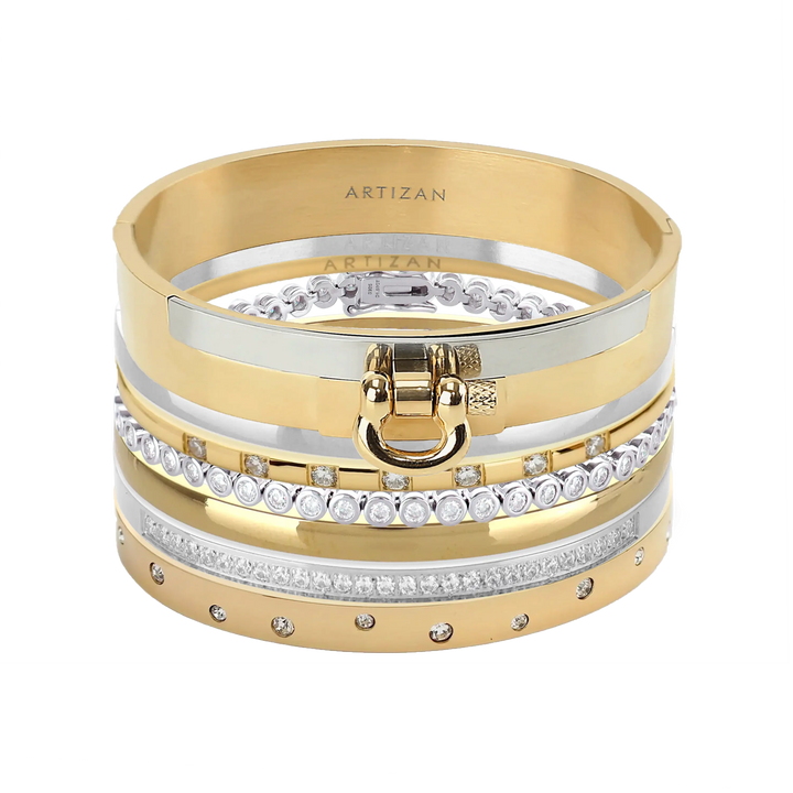 The ICONIC BRACELET STACK which is a stack of 7 gold and silver bracelets, including designs with crystal accents and a gold bracelet featuring a bold buckle clasp.