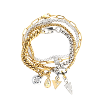 Chain Reaction Bracelet Stack featuring gold and silver chains with diamond-encrusted charms, including a snowflake, teardrop, and triangle.