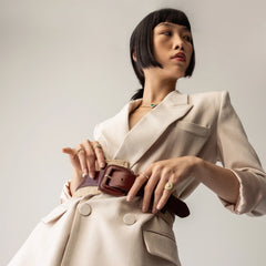 Model wearing the Abuela ring which is a gold textured statement ring with diamond accents in a unique wave design.