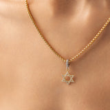 Model wearing a gold necklace with The Gold David’s Star Charm  which is a Six-Pointed Star-Shaped Gold Charm with Diamond Accents. |||