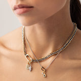 Model wearing the JUST CLICK CHARM PARTY NECKLACE SET showcasing mixed metal chains in gold and silver, adorned with delicate charms, including a lock, teardrop pendant, and crystal accents, elegantly styled on a model's neck.
