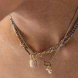 Model wearing the JUST CLICK CHARM PARTY NECKLACE SET showcasing mixed metal chains in gold and silver, adorned with delicate charms, including a lock, teardrop pendant, and crystal accents, elegantly styled on a model's neck.