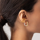 Model wearing the Full Eternity Ear Cuff, a bold gold-tone cuff adorned with sparkling stones, offering a statement look without piercings.|||Gold