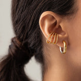Model wearing the Full Eternity Ear Cuff, a bold gold-tone cuff adorned with sparkling stones, offering a statement look without piercings.|||Gold