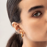 Model wearing the Full Eternity Ear Cuff, a bold silver-tone cuff adorned with sparkling stones, offering a statement look without piercings.|||Silver