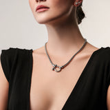 Model wearing the Herradura Signature in silver, a silver necklace featuring a box chain with a silver horseshoe clasp. ||| SILVER
