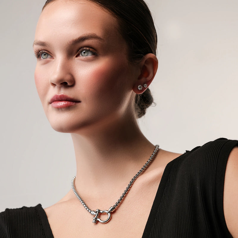 Model wearing the Herradura Signature in silver, a silver necklace featuring a box chain with a silver horseshoe clasp.